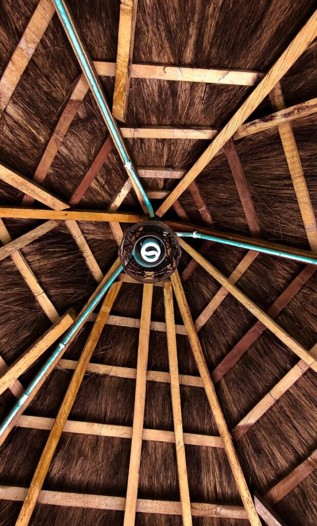 pexels-photo-12896633 Detailed view of a rustic thatched roof ceiling with wooden planks, showcasing traditional architecture in Lagos, Nigeria.
