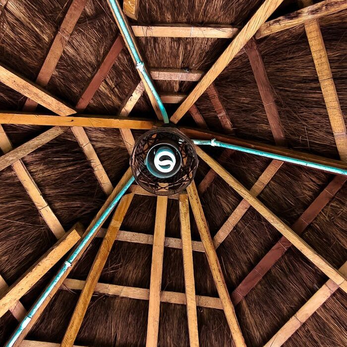 pexels-photo-12896633 Detailed view of a rustic thatched roof ceiling with wooden planks, showcasing traditional architecture in Lagos, Nigeria.