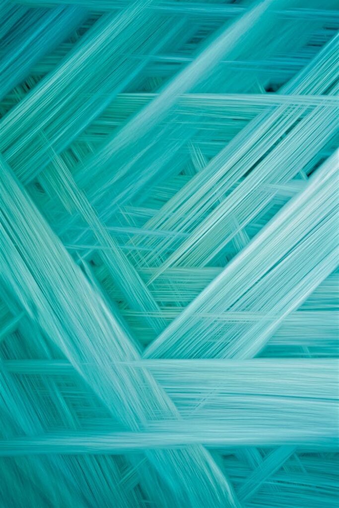 pexels-photo-25748687 A vibrant abstract pattern of turquoise fibers, ideal as a modern background or textured wallpaper.